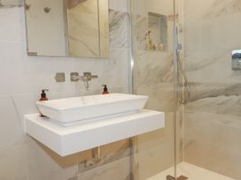 A bathroom with a sink and shower at Apartment 8