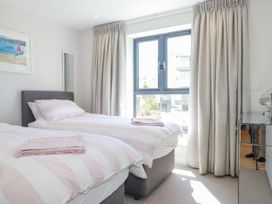 A bedroom with twin beds and a large window at Apartment 8 