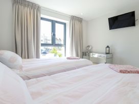 A bedroom with two beds and a window at Apartment 8 