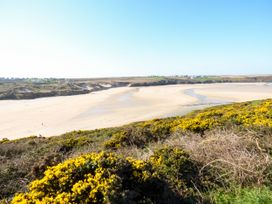 A beach with sand and water at Beach View Fistral in Newquay