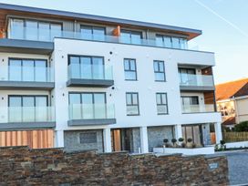 A building with balconies and a stone wall at Beach View Fistral in Newquay