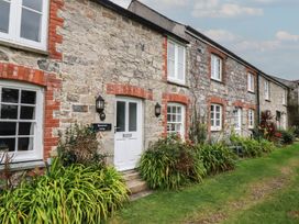 A stone cottage exterior with plants at Honeysuckle Cottage in Charlestown