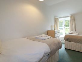 A bedroom with two beds and a dresser at Honeysuckle Cottage in Charlestown
