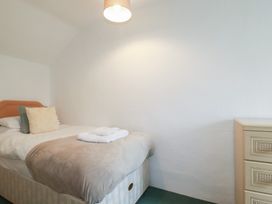 A bedroom with a bed and a chest of drawers at Honeysuckle Cottage in Charlestown