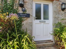An entrance with a door and a house sign at Honeysuckle Cottage in Charlestown