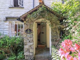 An entryway with a stone structure and a door at Daffodils Ambleside