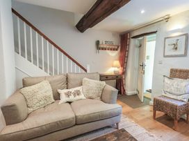 A living room with a sofa and coffee table at Daffodils in Ambleside