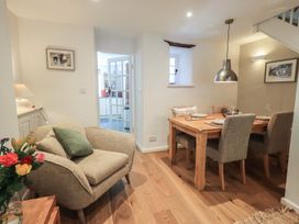 A dining room with an armchair and dining table at Daffodils in Ambleside