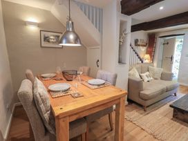 A dining room with a table and chairs and a sofa at Daffodils in Ambleside