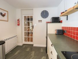 A kitchen with appliances and a door leading outside at Daffodils in Ambleside