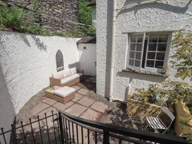 An outdoor seating area with a sofa and table at Daffodils in Ambleside