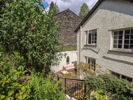 An outdoor area with a sofa next to a house at Daffodils in Ambleside