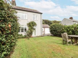 A house with a garden and patio furniture at Driftwood