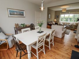 A dining room with a table and chairs at Driftwood in 