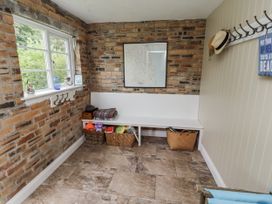 A room with a bench and baskets at Driftwood in 