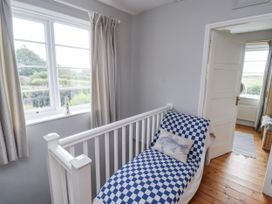 A bedroom with a bed and window at Driftwood