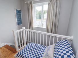 A landing area with a bench and window at Driftwood