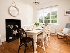 A dining room with a table and chairs at Driftwood in Embleton