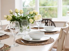 A dining table set with plates and glasses at Driftwood in Embleton