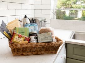 A kitchen with a basket of snacks on the counter at Driftwood in Embleton