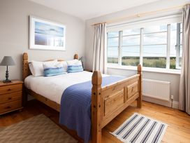 A bedroom with a bed and window at Driftwood in Embleton
