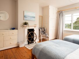 A bedroom with two beds and a dresser at Driftwood in Embleton