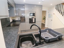 A kitchen with a sink and dish rack at Boslowen in Portreath