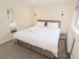 A bedroom with a bed and bedside table at Boslowen in Portreath