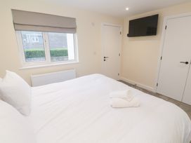 A bedroom with a bed and television at Boslowen in Portreath