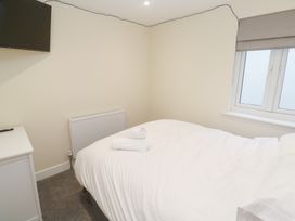 A bedroom with a bed and television at Boslowen in Portreath