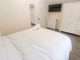 A bedroom with a bed and wardrobe at Boslowen in Portreath