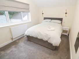 A bedroom with a bed and bedside table at Boslowen in Portreath