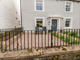 A house with a fence and chairs in front at 1 Brookside in Warcop