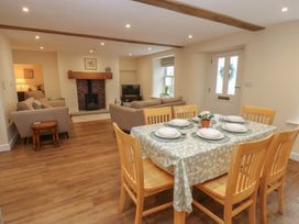 A dining room with a table and chairs at 1 Brookside in Warcop