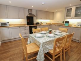 A kitchen with a dining table and chairs at 1 Brookside in Warcop