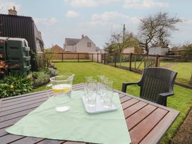 A table with a pitcher and glasses in a garden at 1 Brookside Warcop