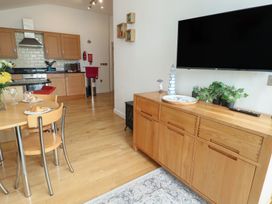 A kitchen and dining area with furniture at Seaview in Benllech near Red Wharf Bay