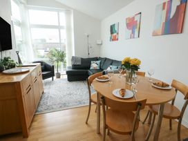 A dining room with a table set for breakfast at Seaview in Benllech near Red Wharf Bay