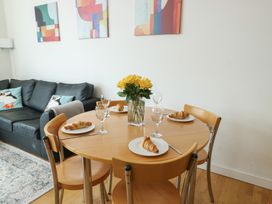 A dining room with a table set for breakfast at Seaview in Benllech near Red Wharf Bay