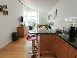 A kitchen with a countertop and seating at Seaview in Benllech near Red Wharf Bay