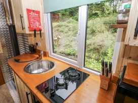 A kitchen with a sink and gas stove at The Hamper in Felingwm near Carmarthen