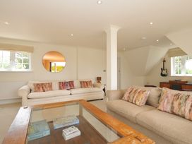 A living room with sofas, a coffee table and a guitar at Bodare 8 in Daymer Bay