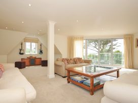 A living room with a coffee table and guitars at Bodare 8 in Daymer Bay