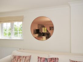 A living room with a mirror and window at Bodare 8 Daymer Bay