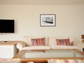A living room with a sofa and coffee table at Bodare 8 in Daymer Bay