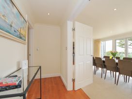 A hallway leading to a dining room with a table and chairs at Bodare 8 in Daymer Bay