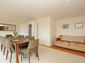 A dining room with a table and chairs at Bodare 8 in Daymer Bay
