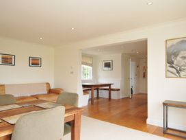 A living room with a sofa and dining table at Bodare 8 in Daymer Bay