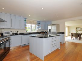 A kitchen with cabinets and appliances at Bodare 8 in Daymer Bay