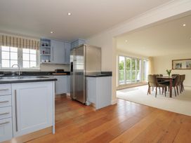 A kitchen with a refrigerator and sink at Bodare 8 in Daymer Bay